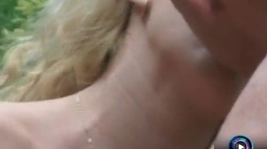 Curly haired blonde Jaqueline Stone giving a wet blowjob outdoors